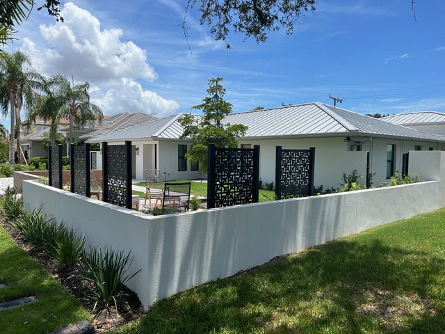 Modern house with decorative fence and garden.