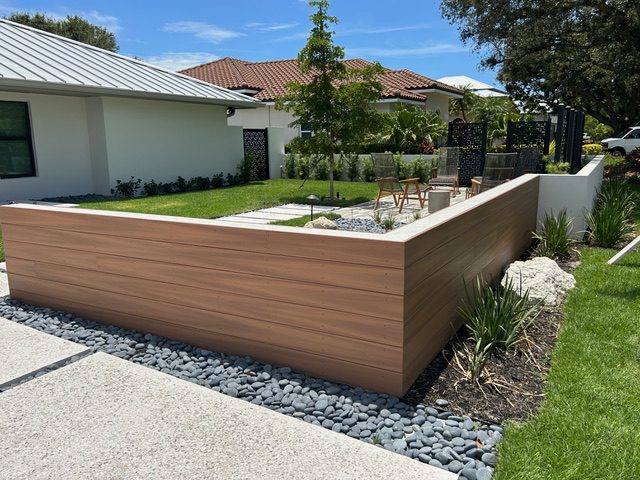 Modern garden with wooden fence and landscaping.
