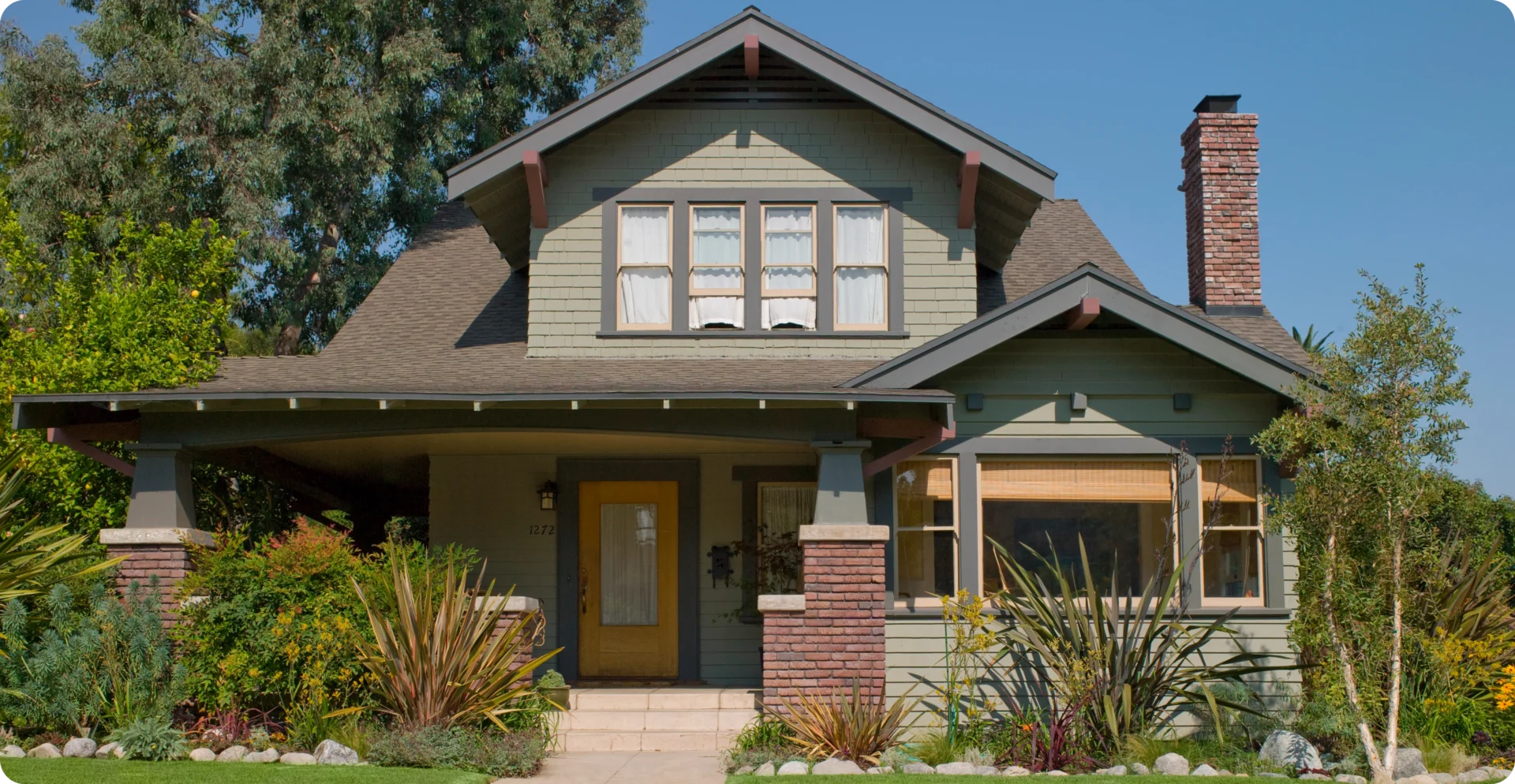 Craftsman-style house with a landscaped yard.