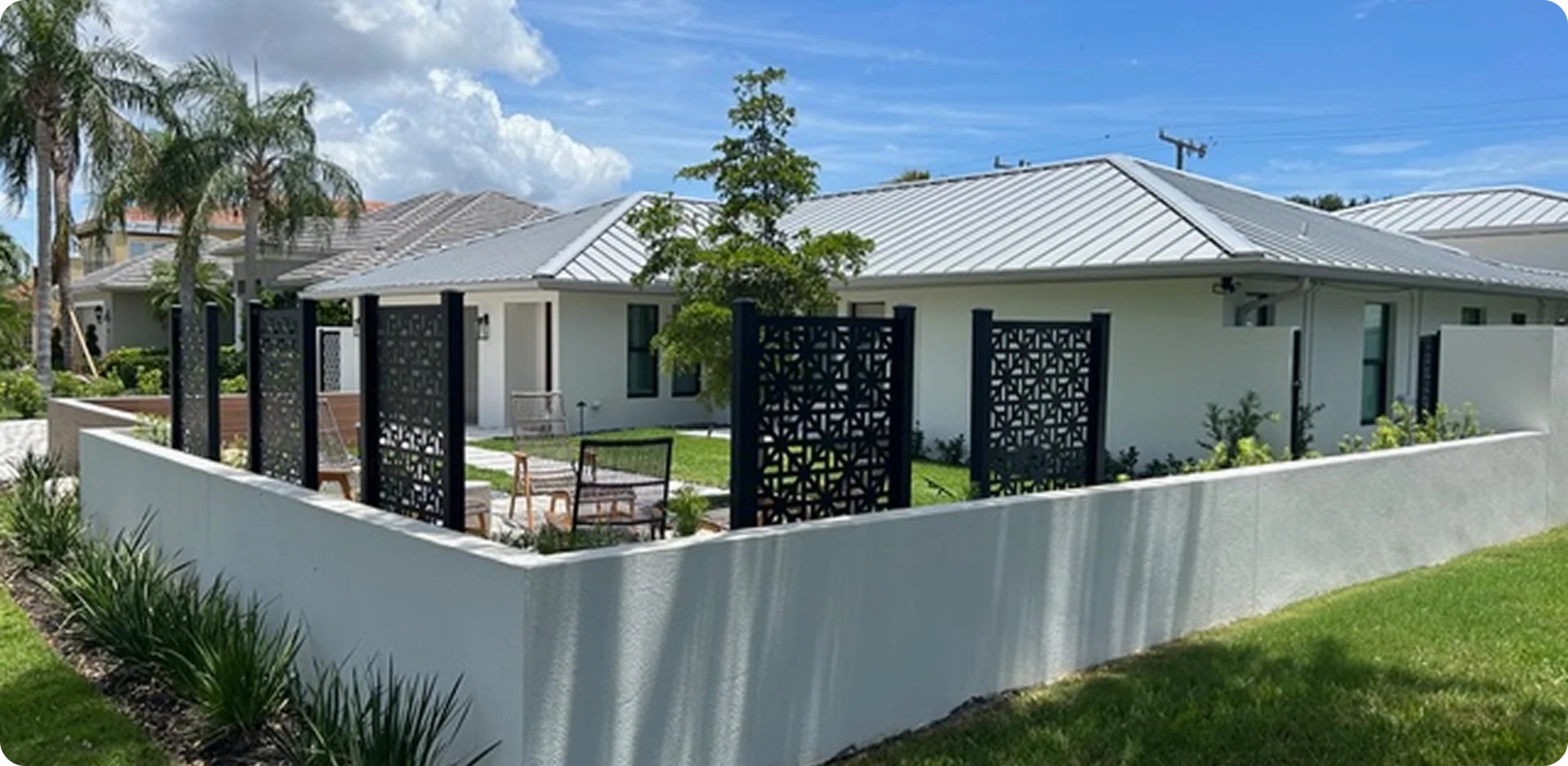 Modern house with decorative privacy screens outside.