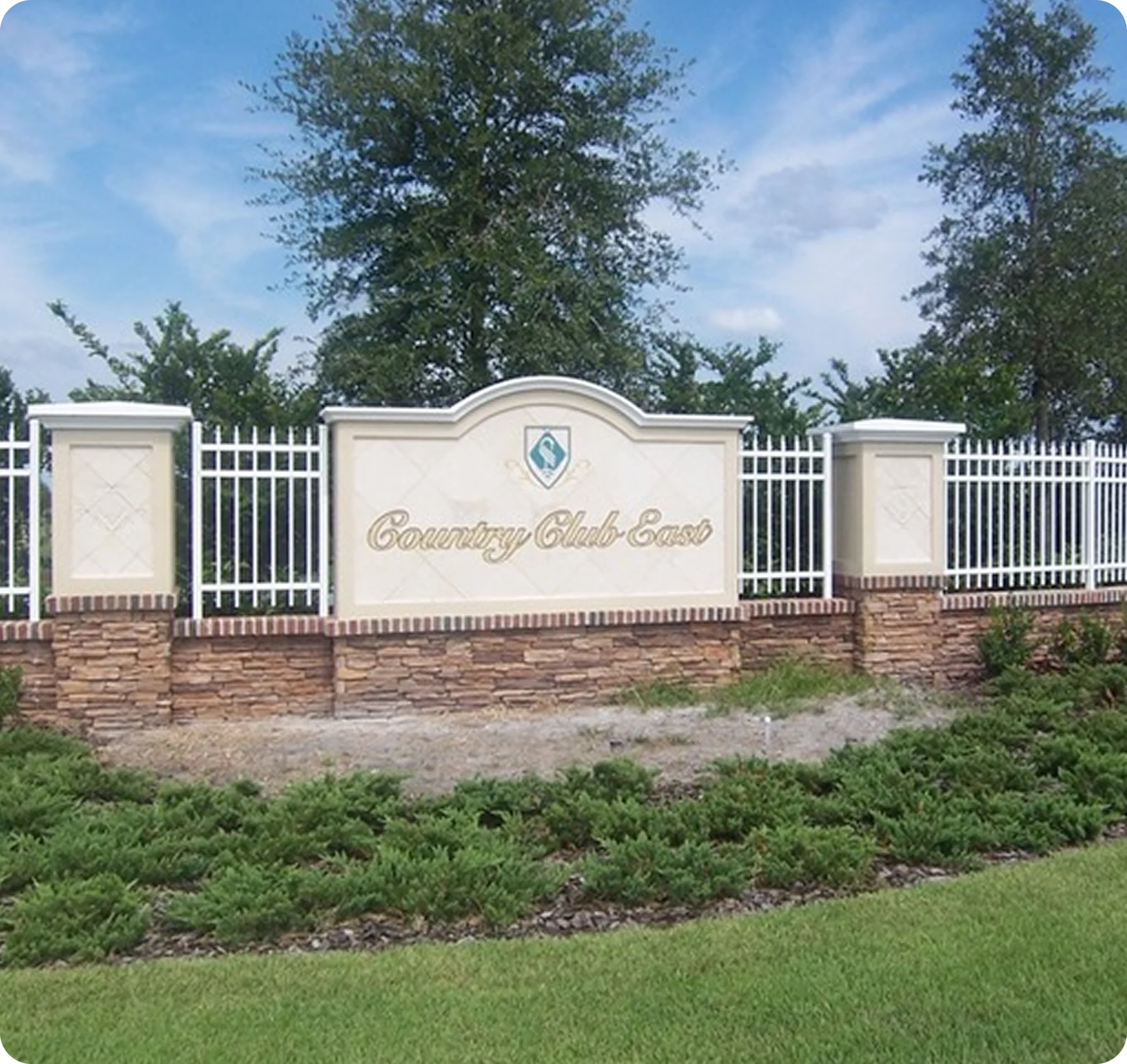 Country Club East entrance sign with landscaping.