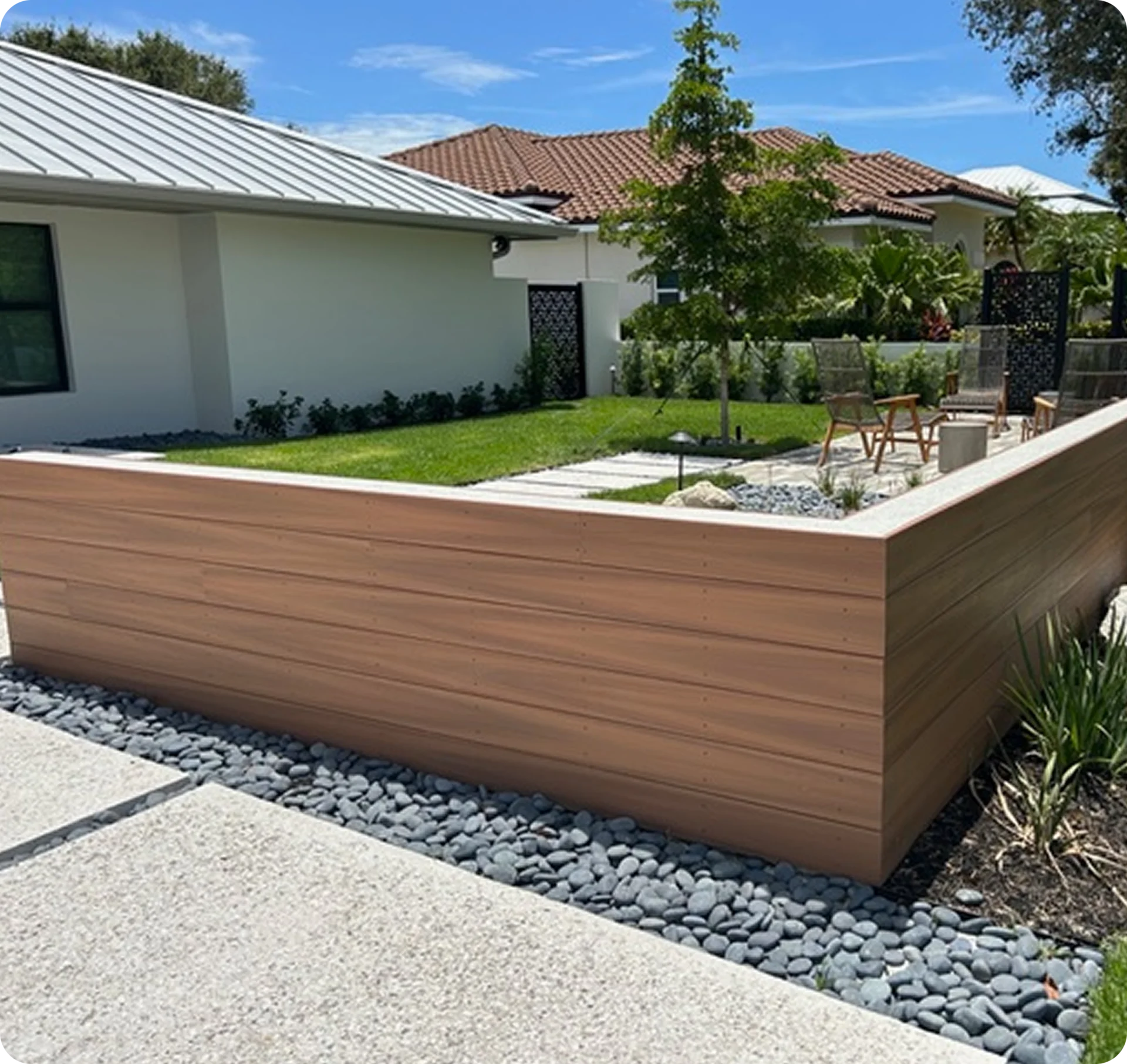 Modern backyard patio with raised garden area.