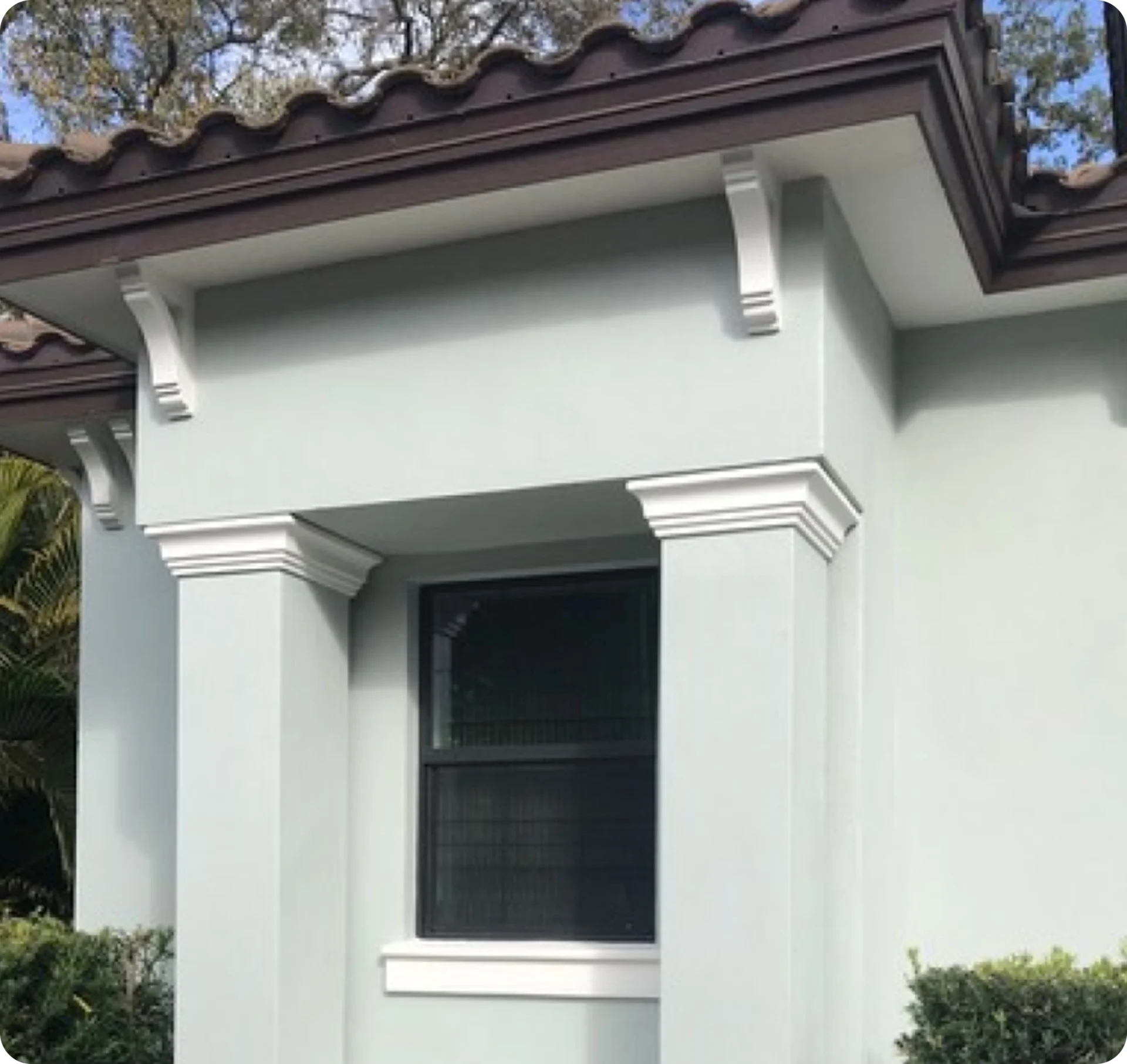House exterior with window and decorative columns.